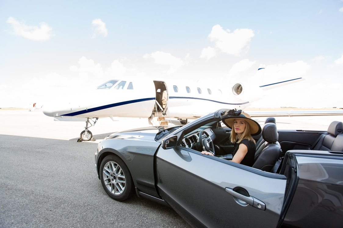 Woman Disembarking Car with Private Jet